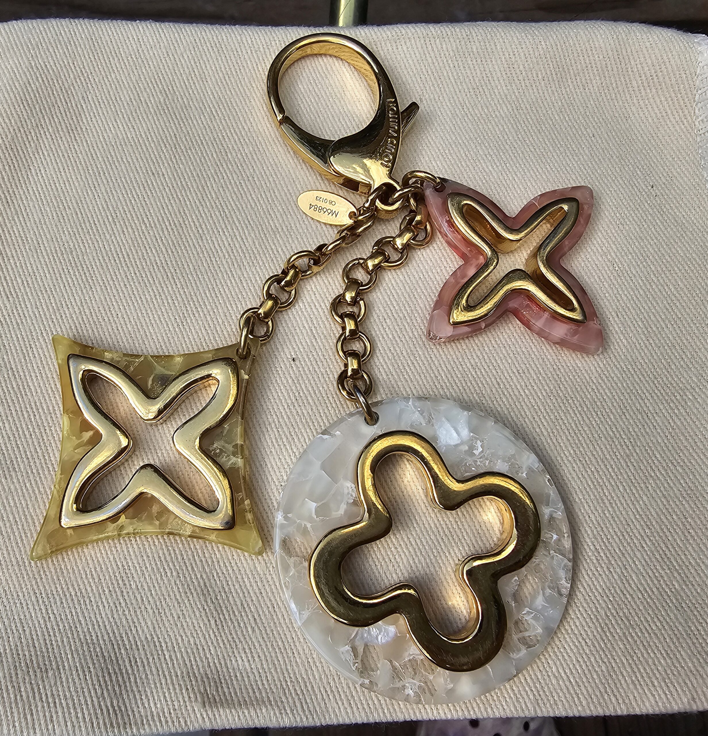 Louis Vuitton Insolence key holder and bag charm with pink, yellow and pearly white resin Monogram charms on a gold-tone chain