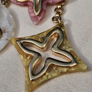 Pink marbled star and golden yellow diamond resin charms on the Louis Vuitton Insolence bag charm
