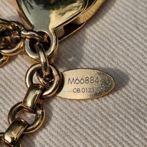 Plaque stamped M66884 and date code OB0123 on the Louis Vuitton Insolence bag charm