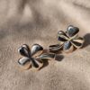Angled view of the Chanel four leaf clover stud earrings showing the sculpted petals