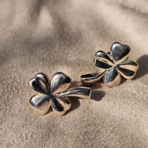 Angled view of the Chanel four leaf clover stud earrings showing the sculpted petals