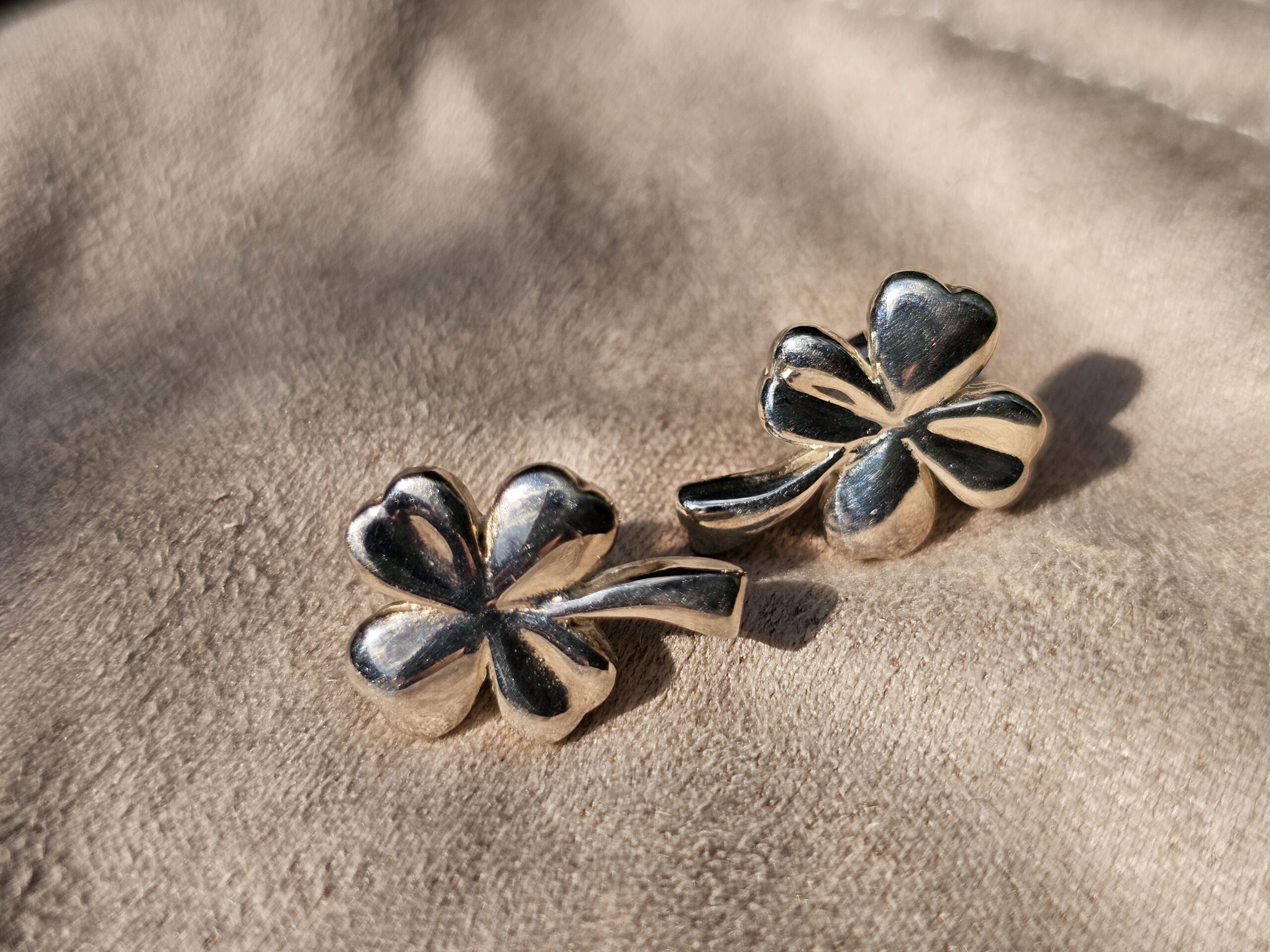 Angled view of the Chanel four leaf clover stud earrings showing the sculpted petals