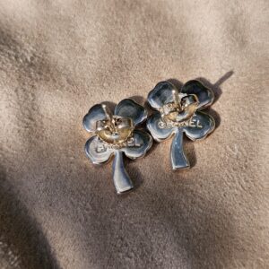 Chanel four leaf clover stud earrings shown with their earring backs attached