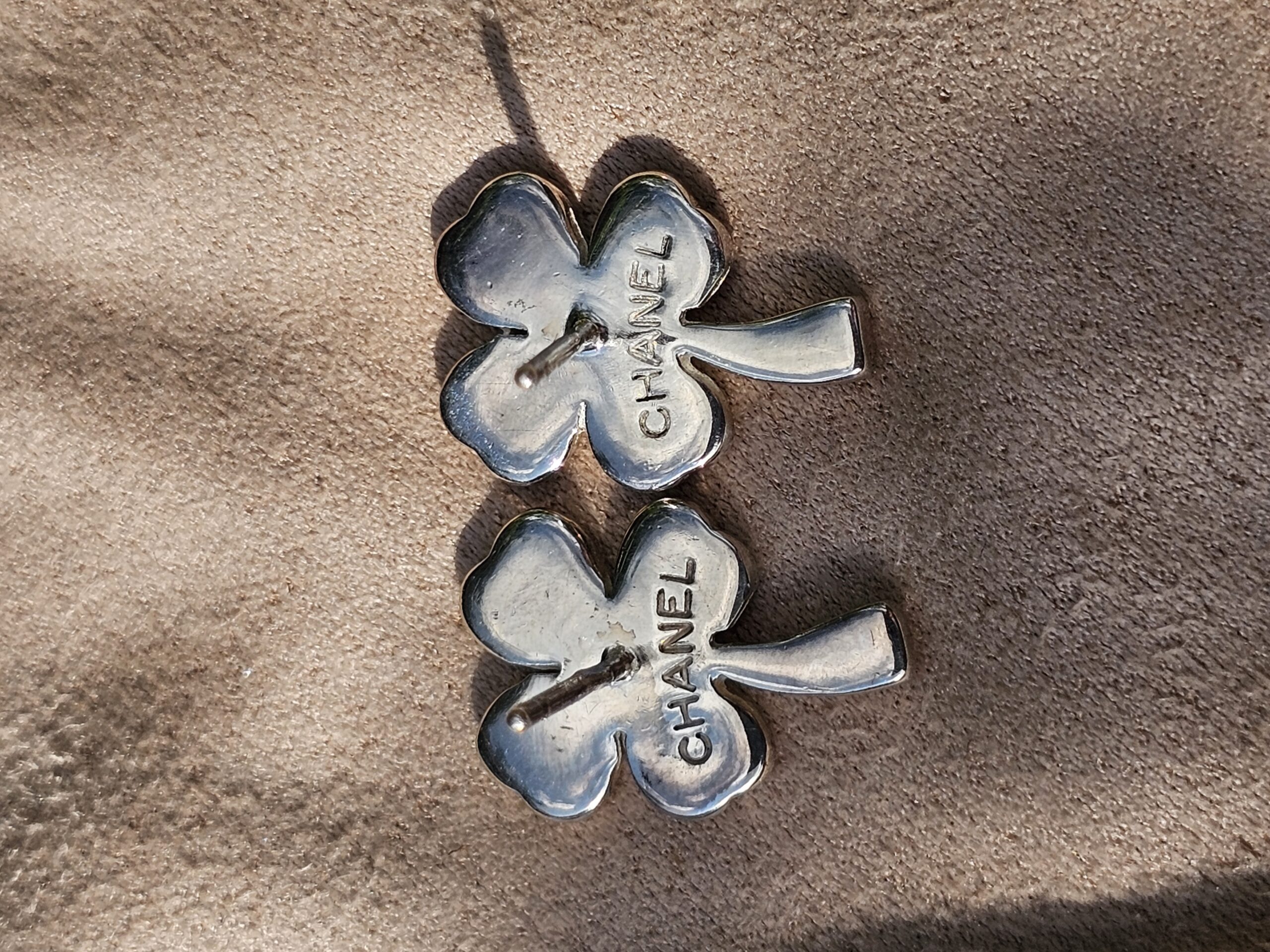 CHANEL stamped on the reverse of both four leaf clover stud earrings