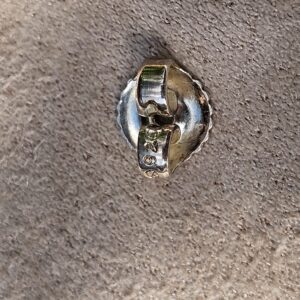 Reverse of a Chanel four leaf clover stud earring showing the post and back