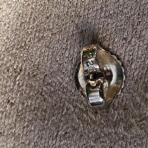 Close-up of the post and back on a Chanel four leaf clover stud earring