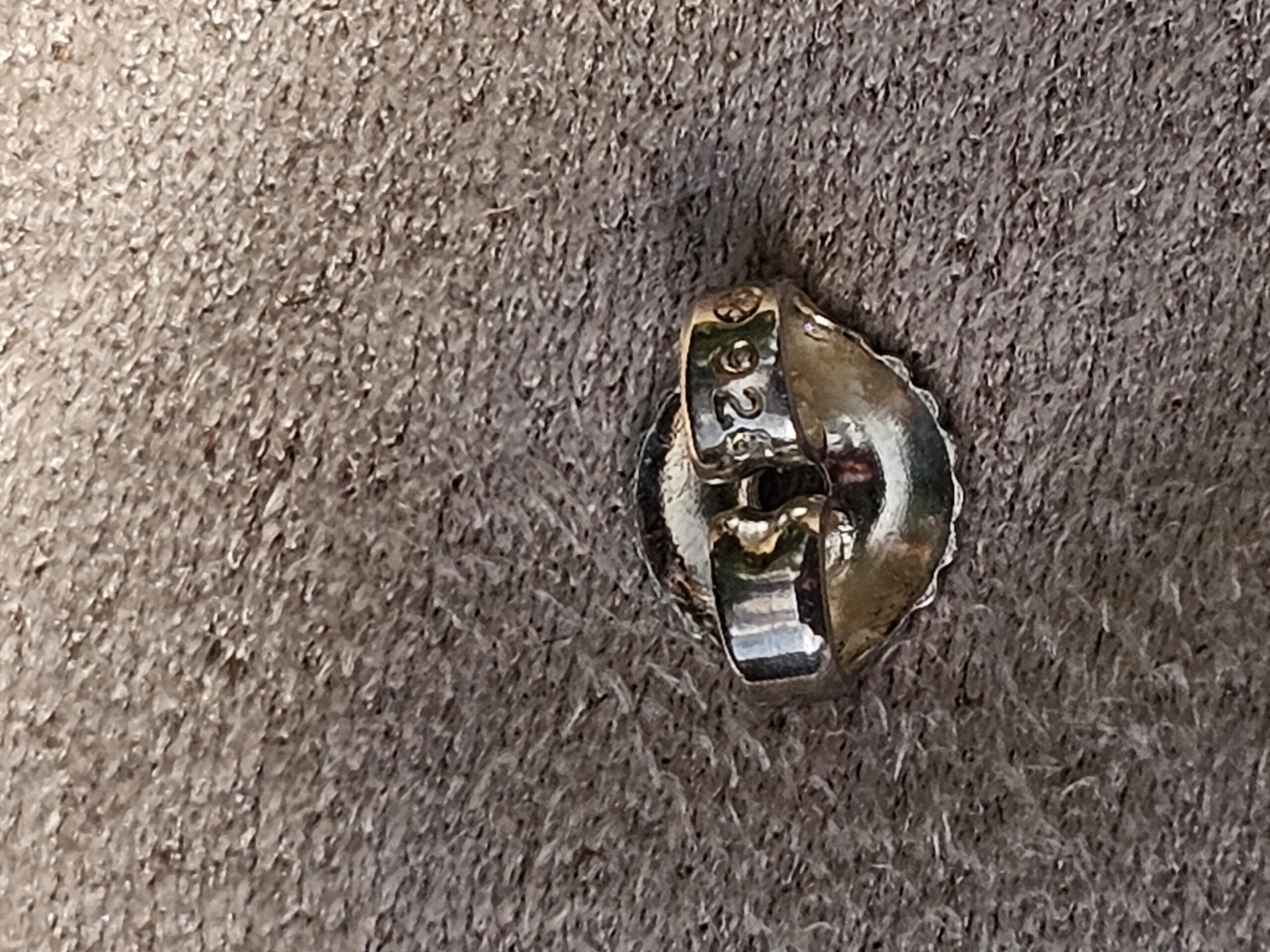 Close-up of the post and back on a Chanel four leaf clover stud earring