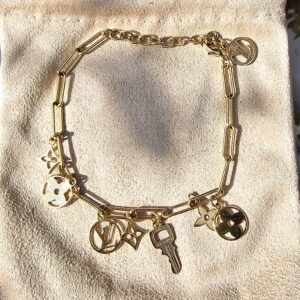 Louis Vuitton Sweet Monogram charm bracelet in gold-tone metal with Monogram flower, medallion and key charms