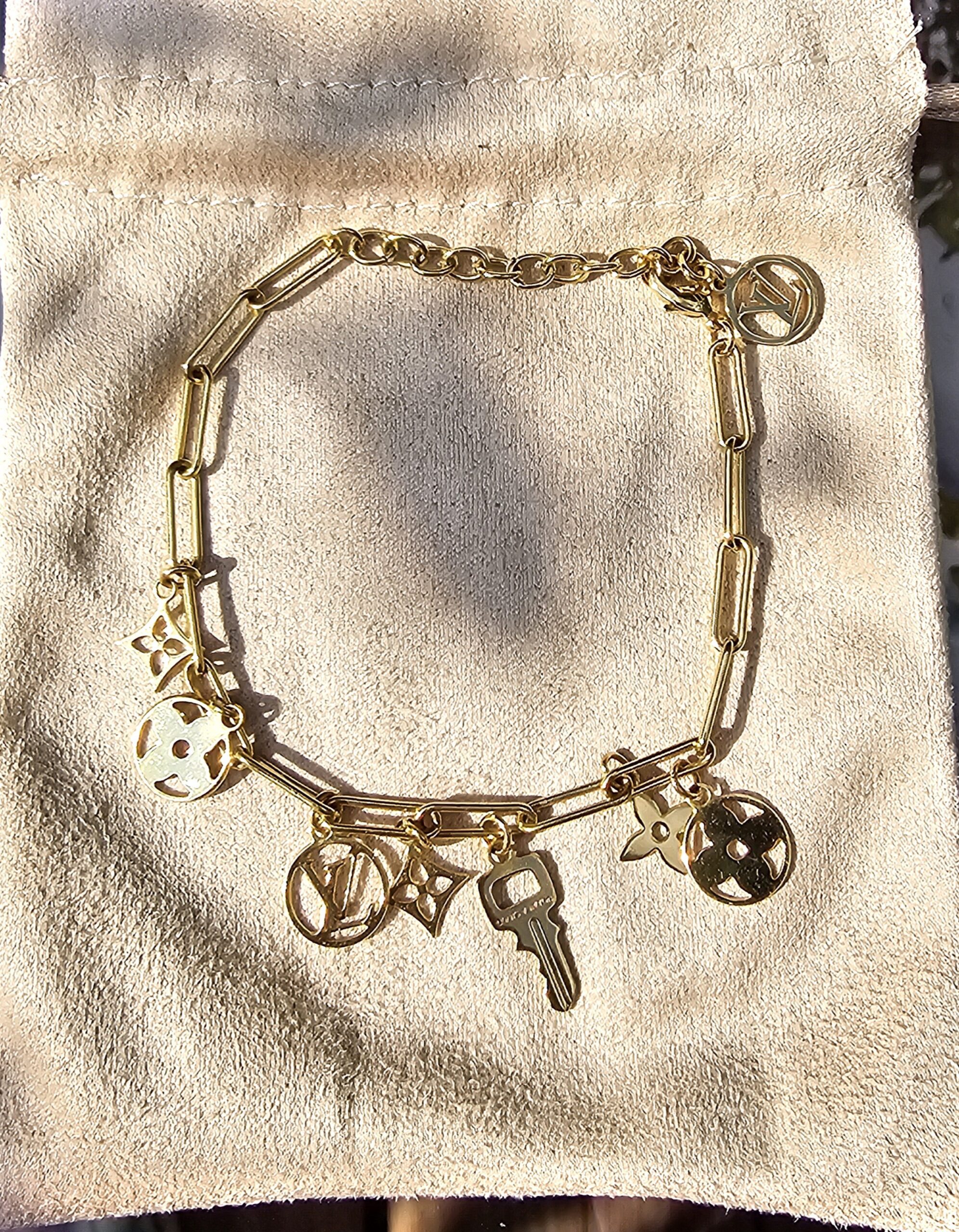 Louis Vuitton Sweet Monogram charm bracelet in gold-tone metal with Monogram flower, medallion and key charms