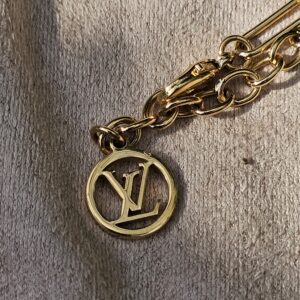 Gold-tone LV medallion charm on the Louis Vuitton Sweet Monogram bracelet