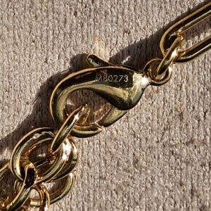 Style M80273 stamped near the lobster clasp of the Louis Vuitton Sweet Monogram bracelet