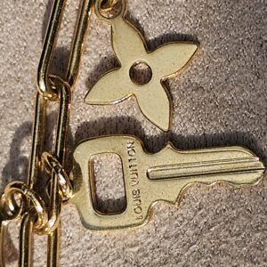 Key charm engraved Louis Vuitton alongside the Monogram flower charm on the Sweet Monogram bracelet