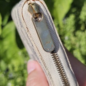 Close-up of the gold-tone zip and hardware on the Louis Vuitton Damier Azur Zippy Coin Purse