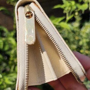 Louis Vuitton Damier Azur Zippy Coin Purse held open showing the interior and zip