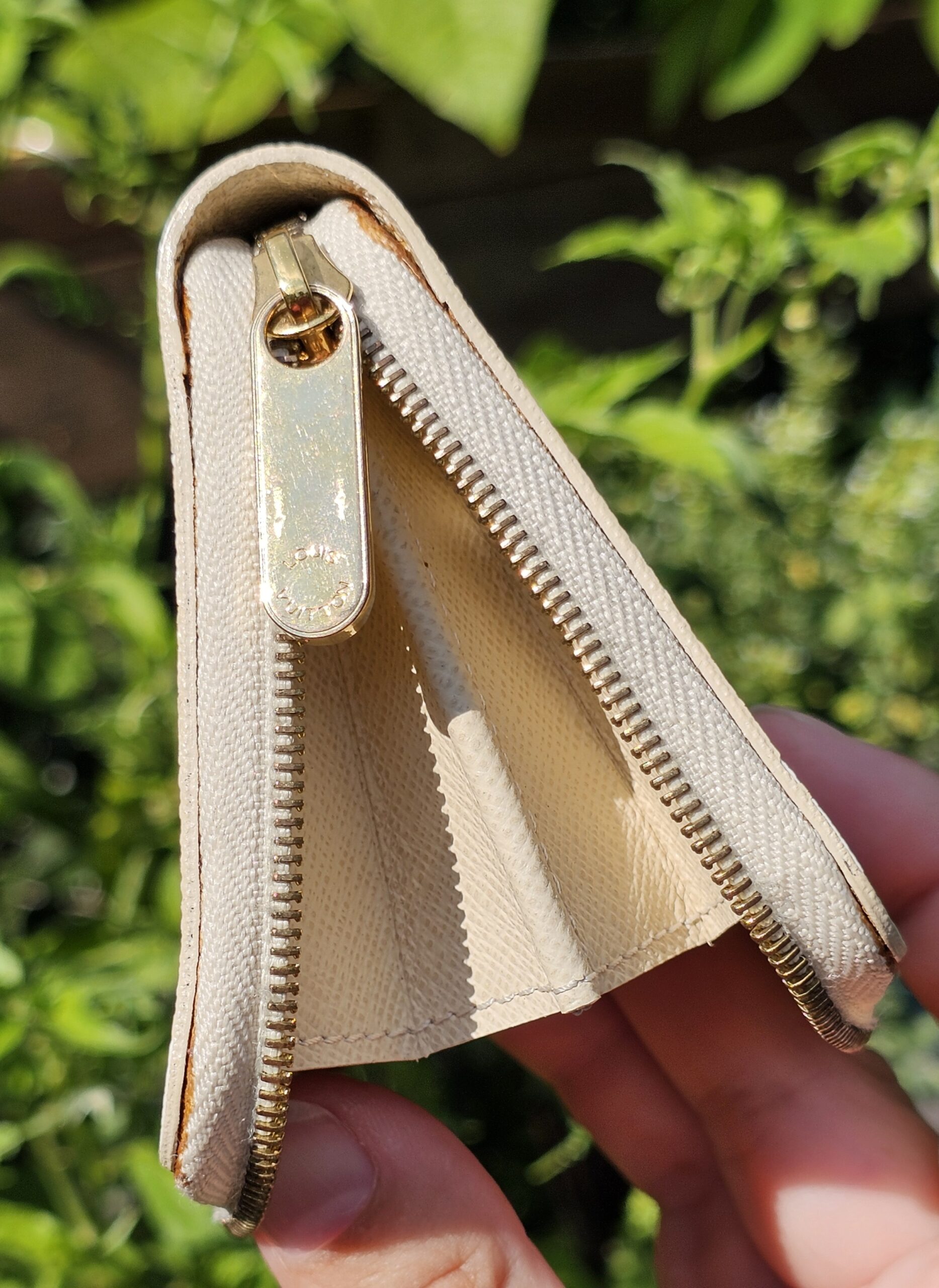 Louis Vuitton Damier Azur Zippy Coin Purse held open showing the interior and zip