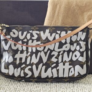 Louis Vuitton x Stephen Sprouse Pochette Accessoires in Monogram canvas with white graffiti lettering and vachetta wrist strap