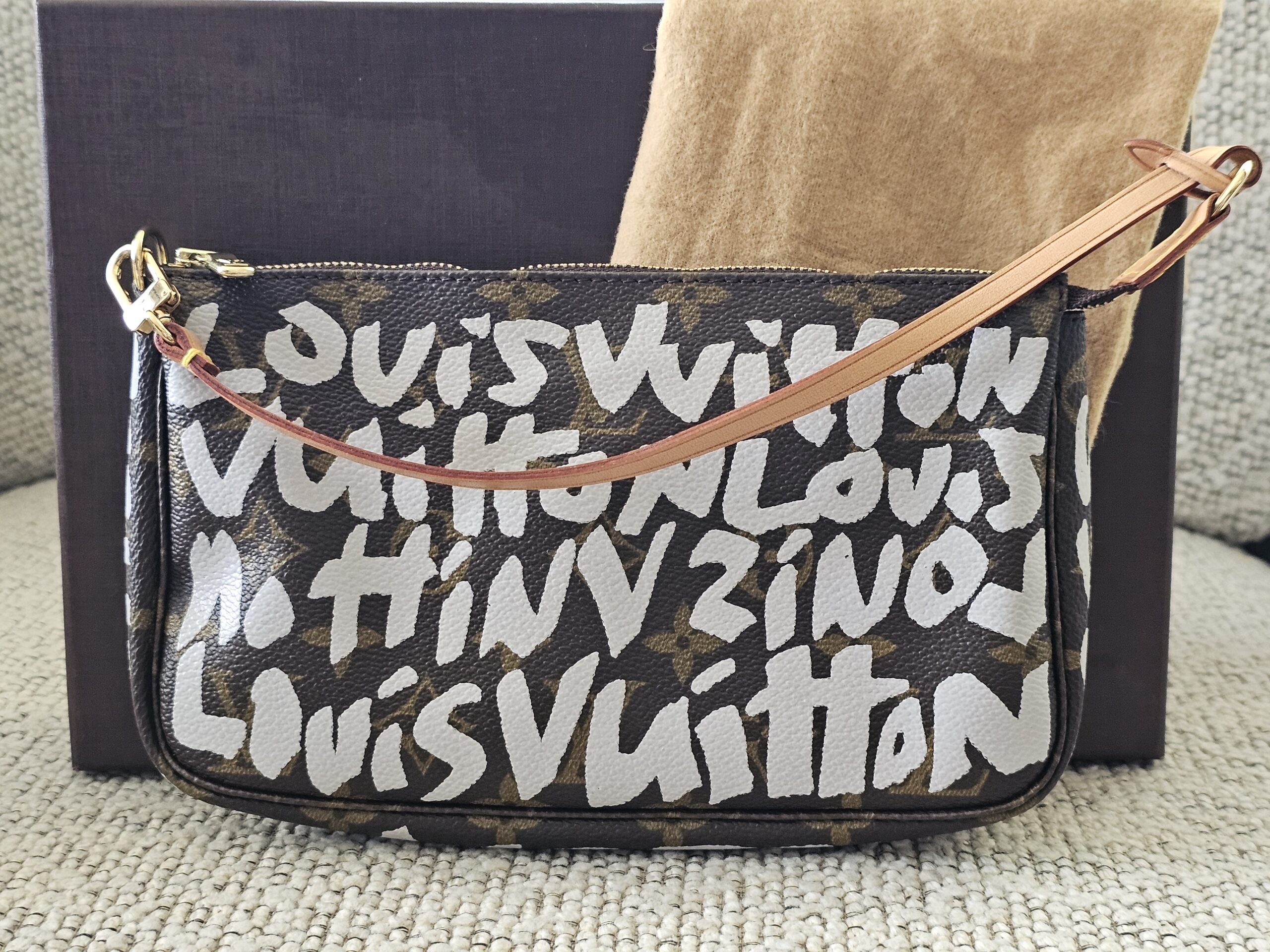 Louis Vuitton x Stephen Sprouse Pochette Accessoires in Monogram canvas with white graffiti lettering and vachetta wrist strap