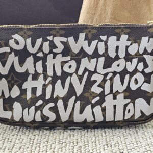 Front of the Louis Vuitton Graffiti Pochette Accessoires showing the white Stephen Sprouse lettering over Monogram canvas