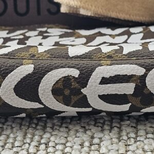 Top of the Louis Vuitton Graffiti Pochette Accessoires showing the graffiti lettering along the zip