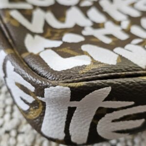 Close-up of the white Stephen Sprouse graffiti print over Louis Vuitton Monogram canvas