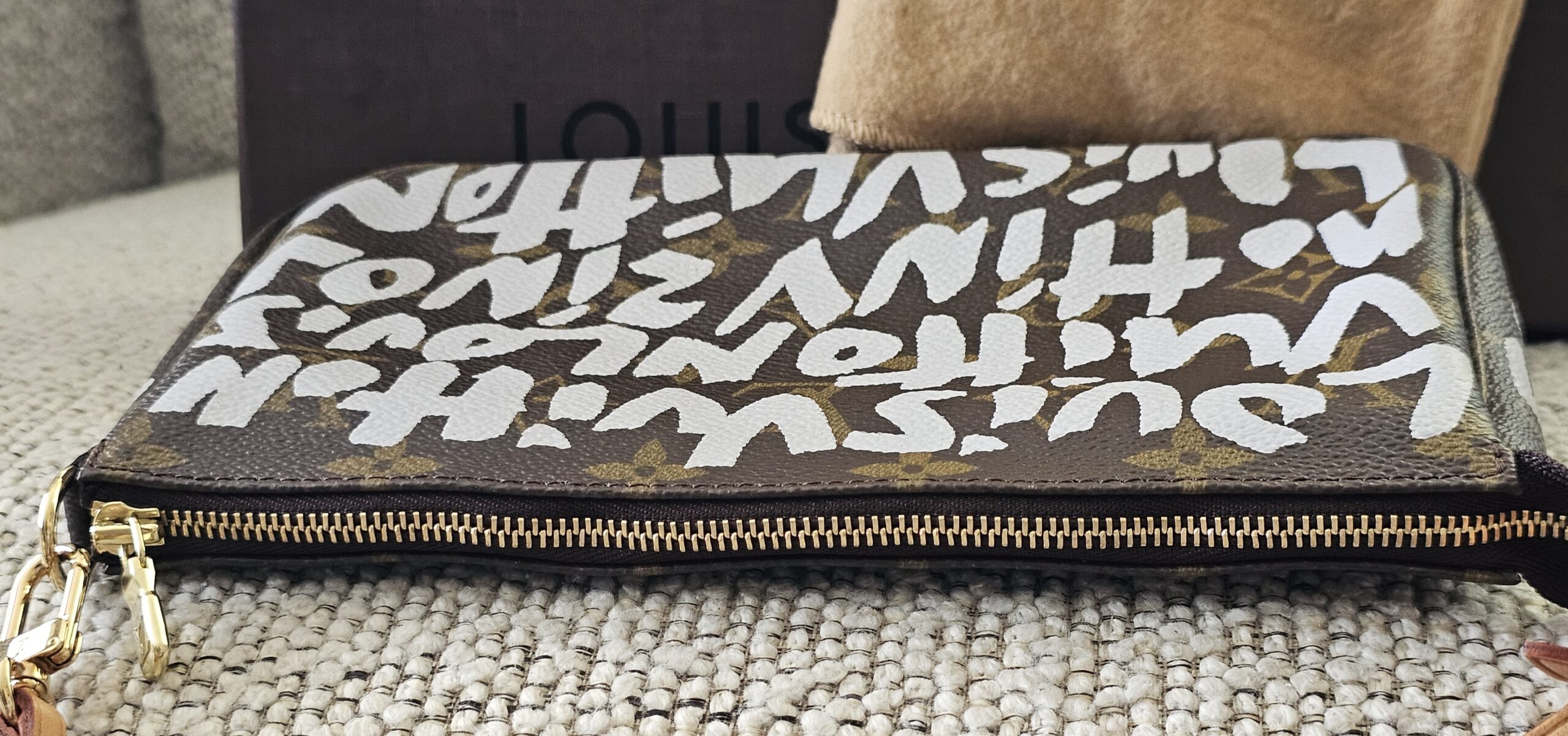Side profile of the Louis Vuitton Graffiti Pochette Accessoires with the zip closed