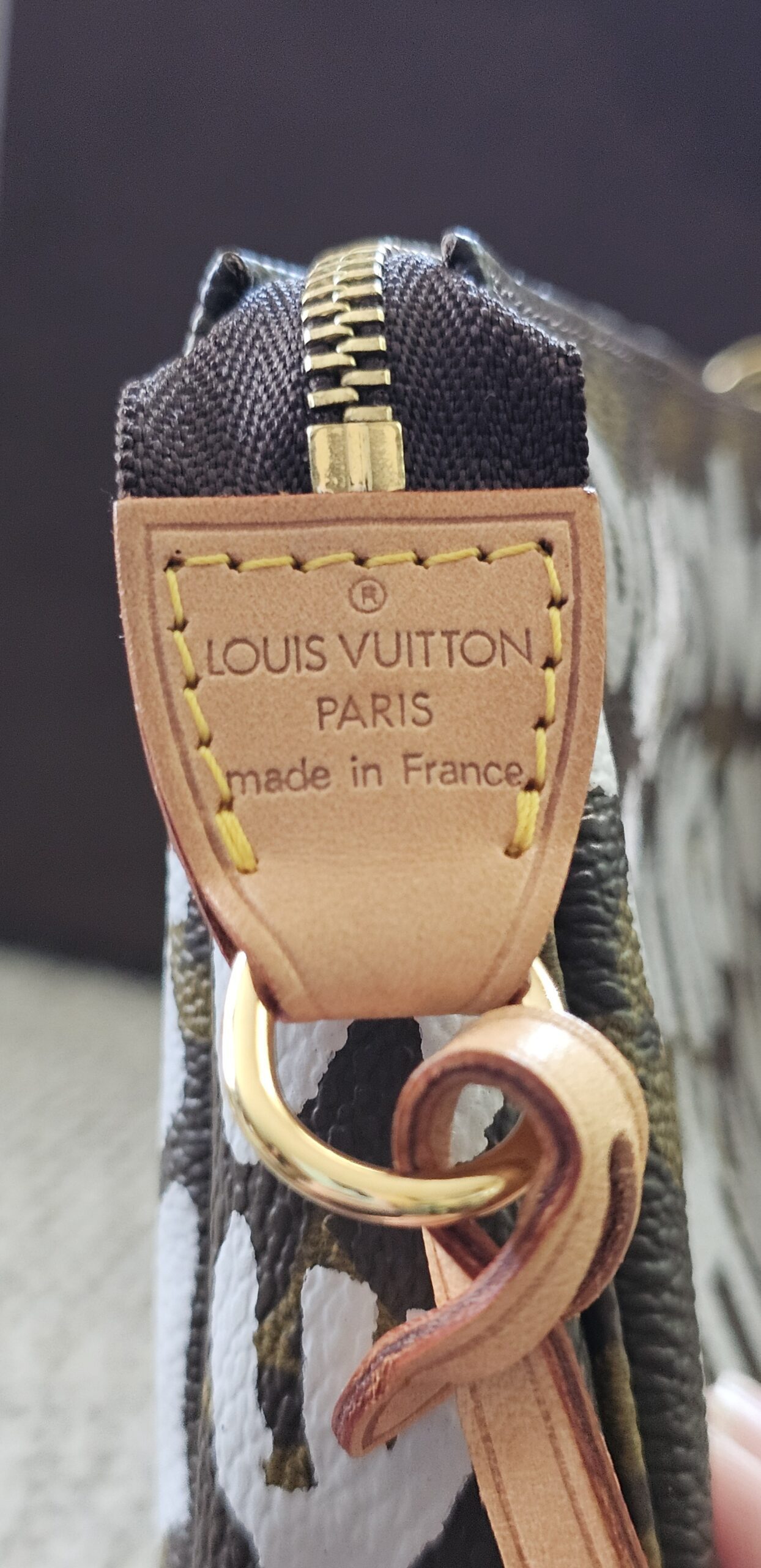 Louis Vuitton Paris made in France heat stamp on the vachetta strap tab of the Graffiti Pochette