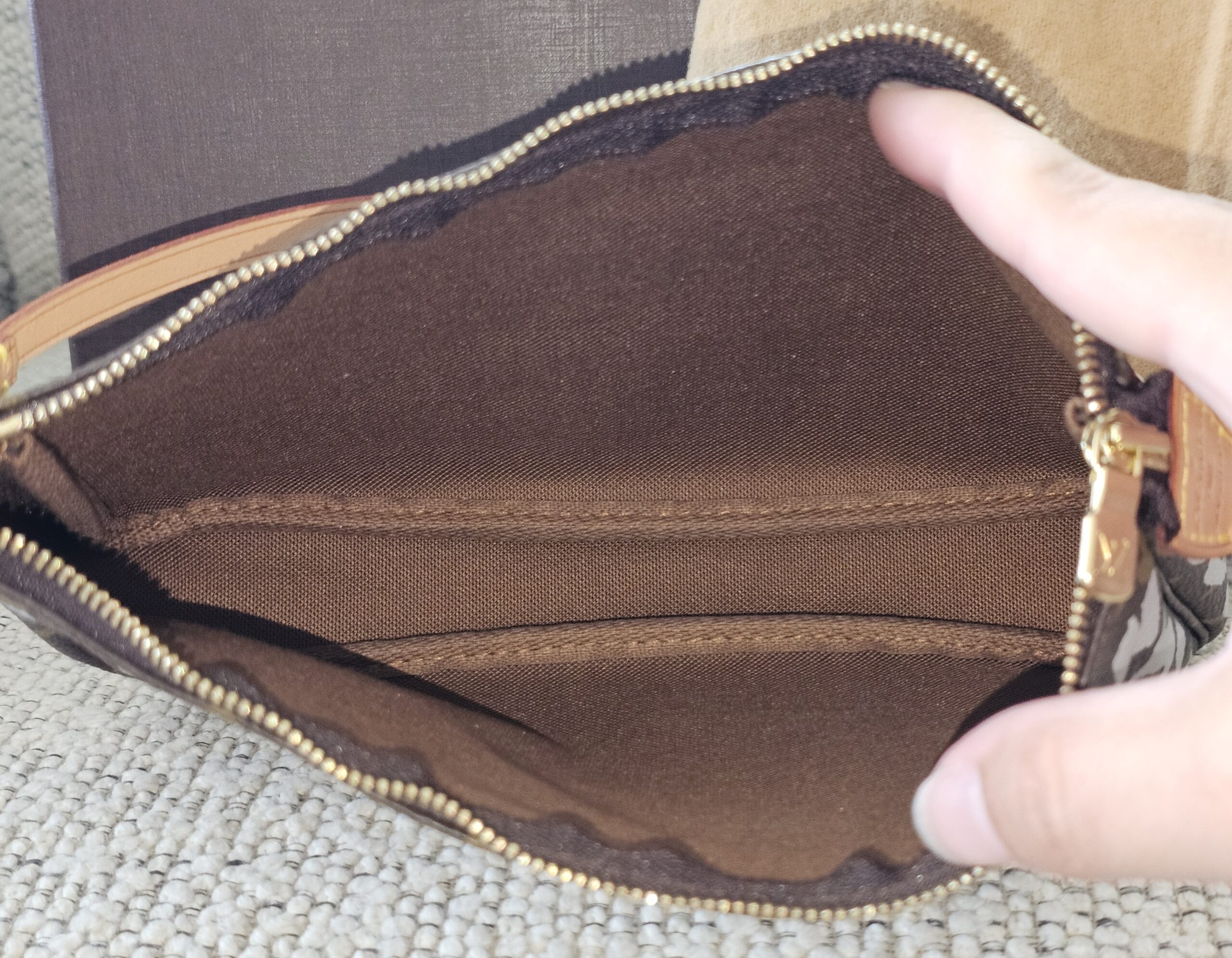 Brown textile interior of the Louis Vuitton Stephen Sprouse Graffiti Pochette Accessoires