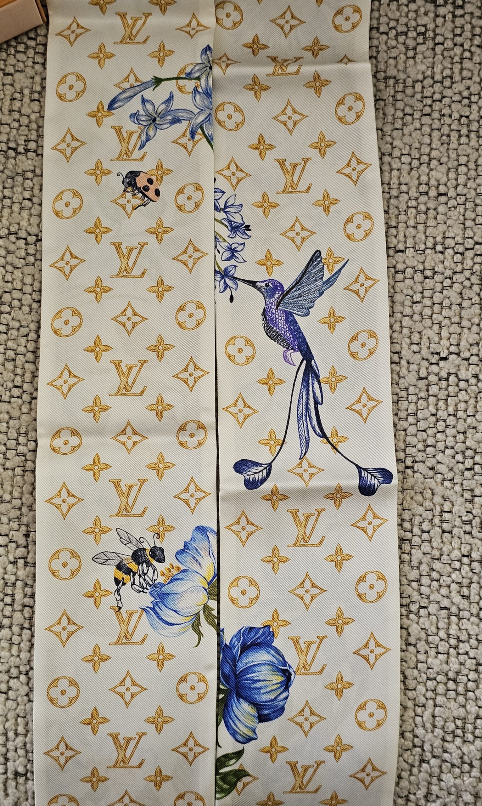 Gold Monogram side of the Louis Vuitton Fontaines Parfumees bandeau with hummingbird and florals