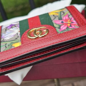 Gold-tone Double G hardware on the front of the Gucci Flora Ophidia compact wallet