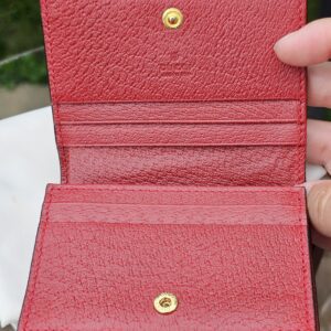 Red leather interior of the Gucci Ophidia compact wallet with card slots and compartments