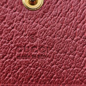 Gucci made in Italy stamp embossed on the red leather interior of the Ophidia wallet