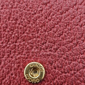 Gold-tone Gucci engraved snap closure inside the Flora Ophidia compact wallet