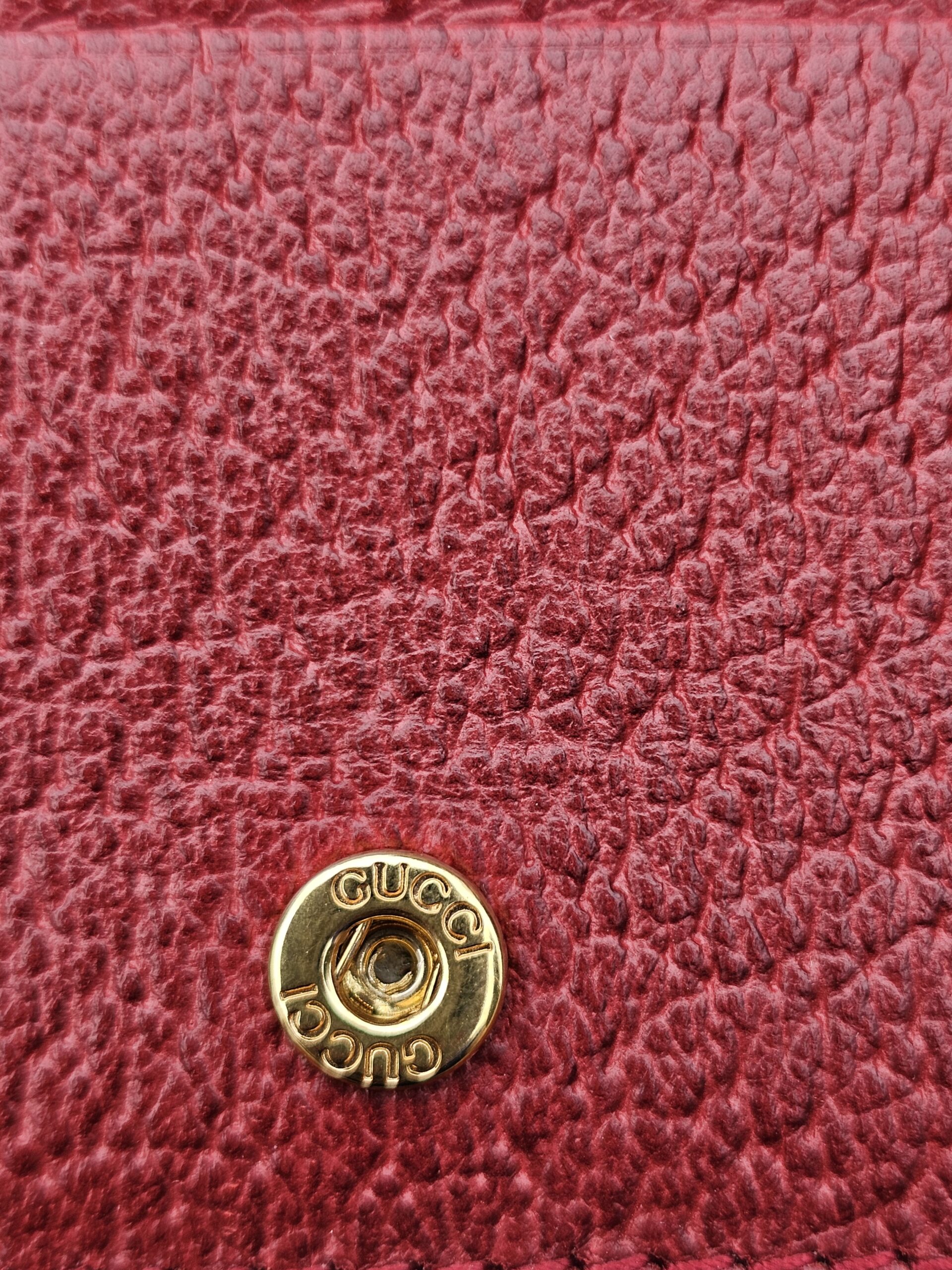 Gold-tone Gucci engraved snap closure inside the Flora Ophidia compact wallet