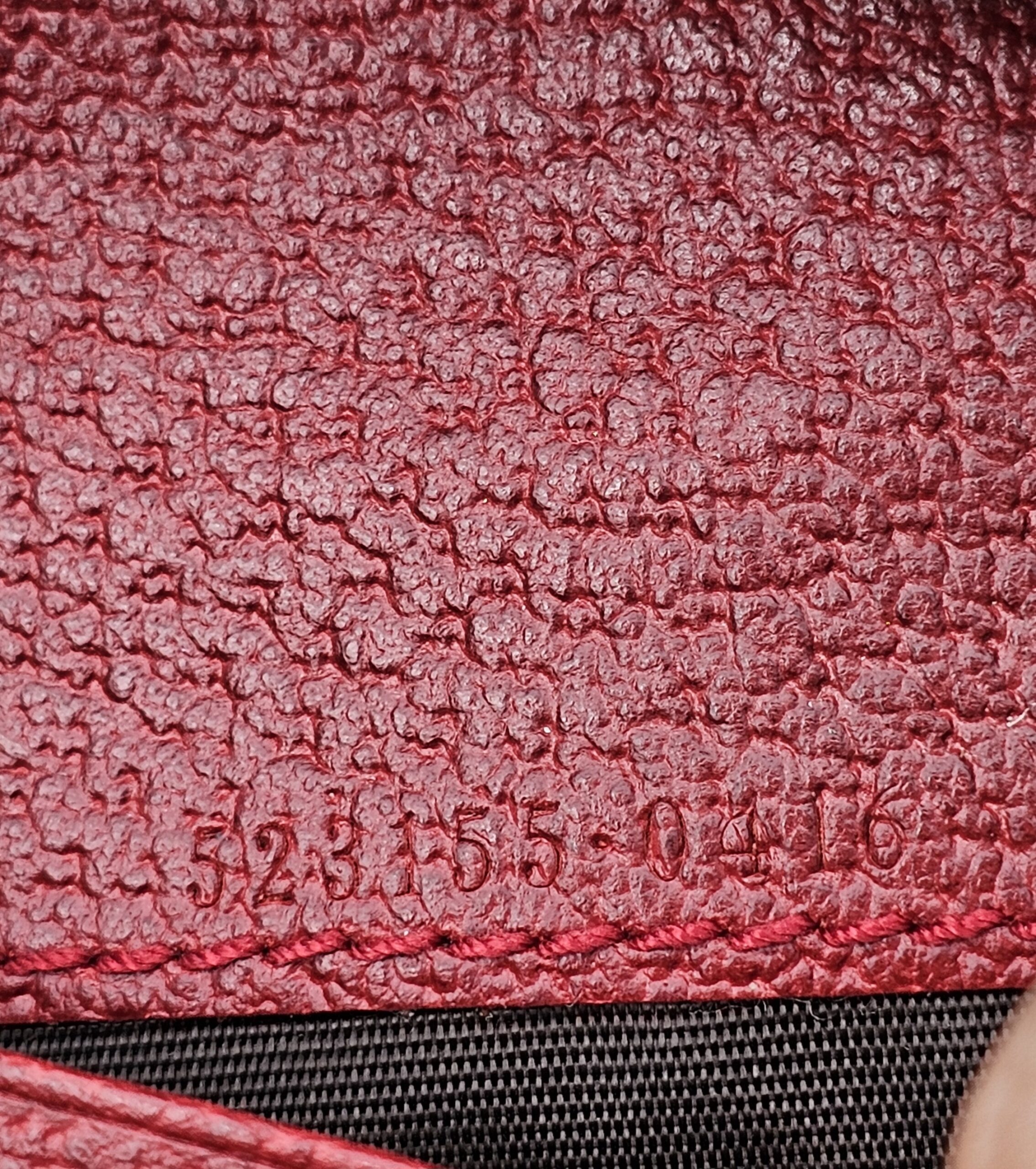 Style code 523155 embossed inside the Gucci Flora Web Ophidia compact wallet