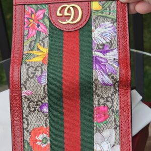Gucci GG Supreme Flora Ophidia compact wallet held in hand to show scale