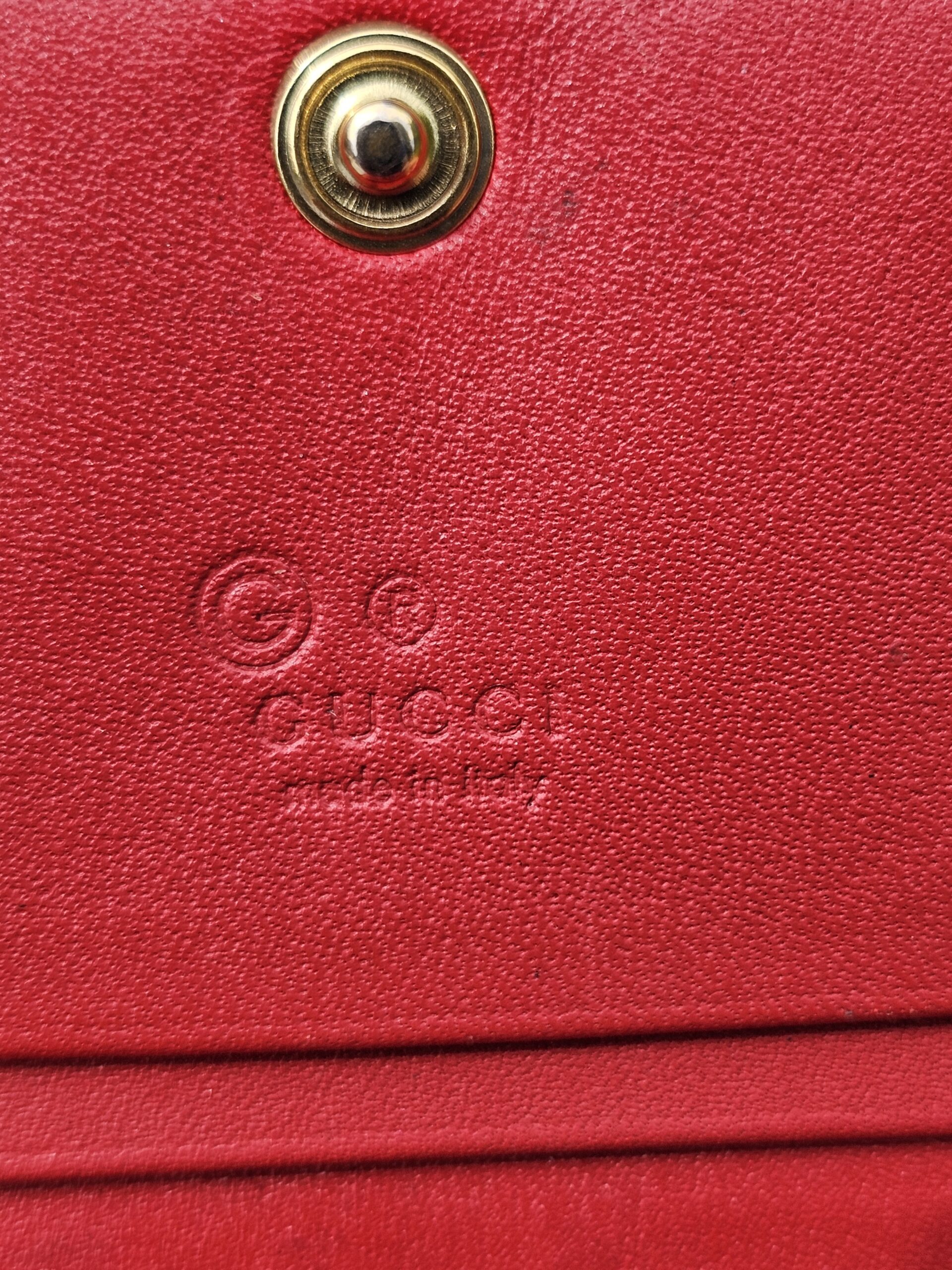 Gucci made in Italy stamp embossed on the red leather interior of the Blooms wallet