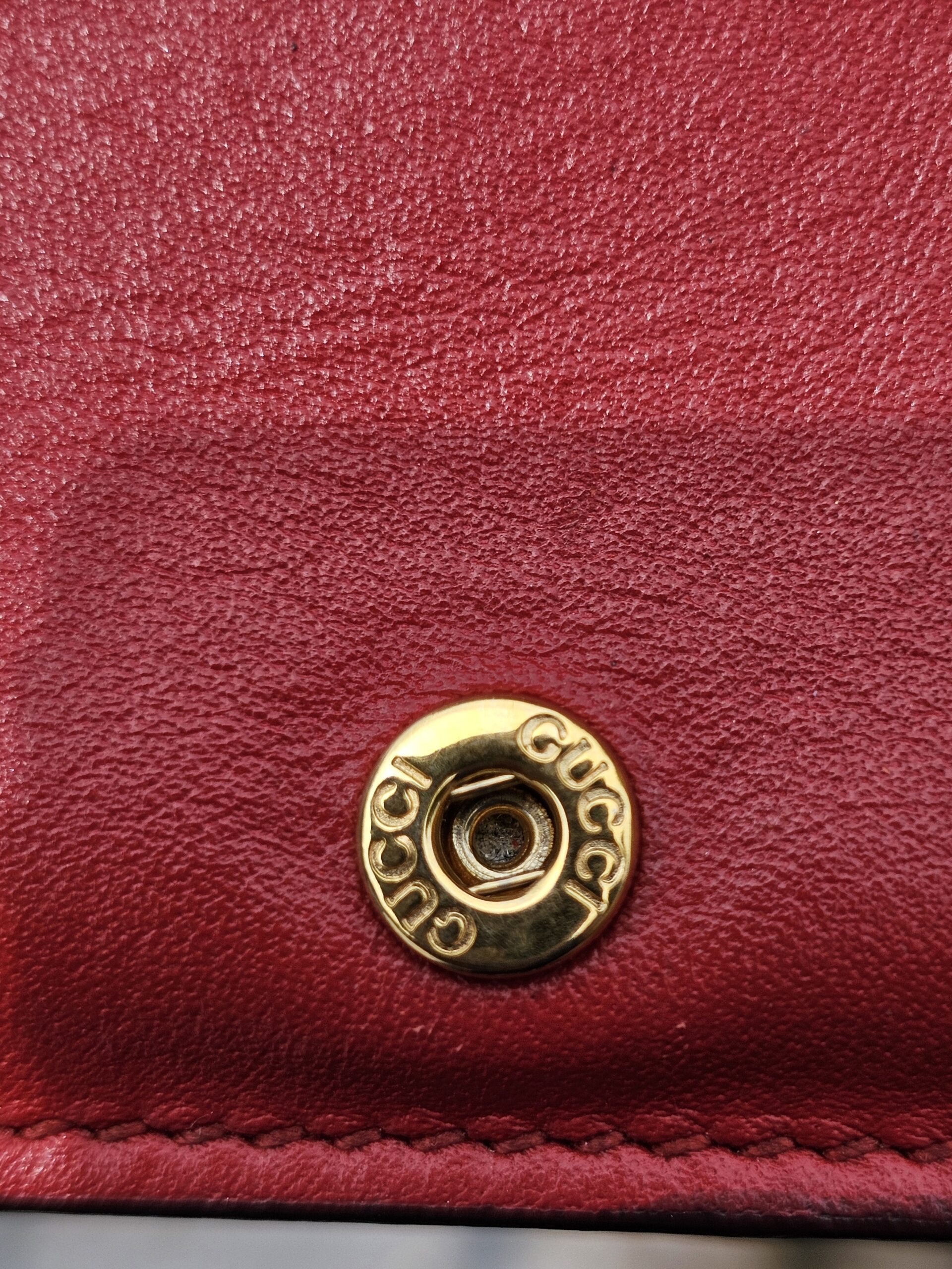 Gold-tone Gucci engraved snap closure inside the Blooms compact wallet