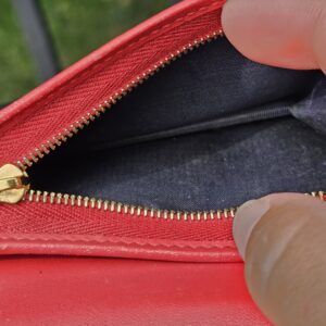 Zippered coin compartment inside the Gucci GG Supreme Blooms compact wallet