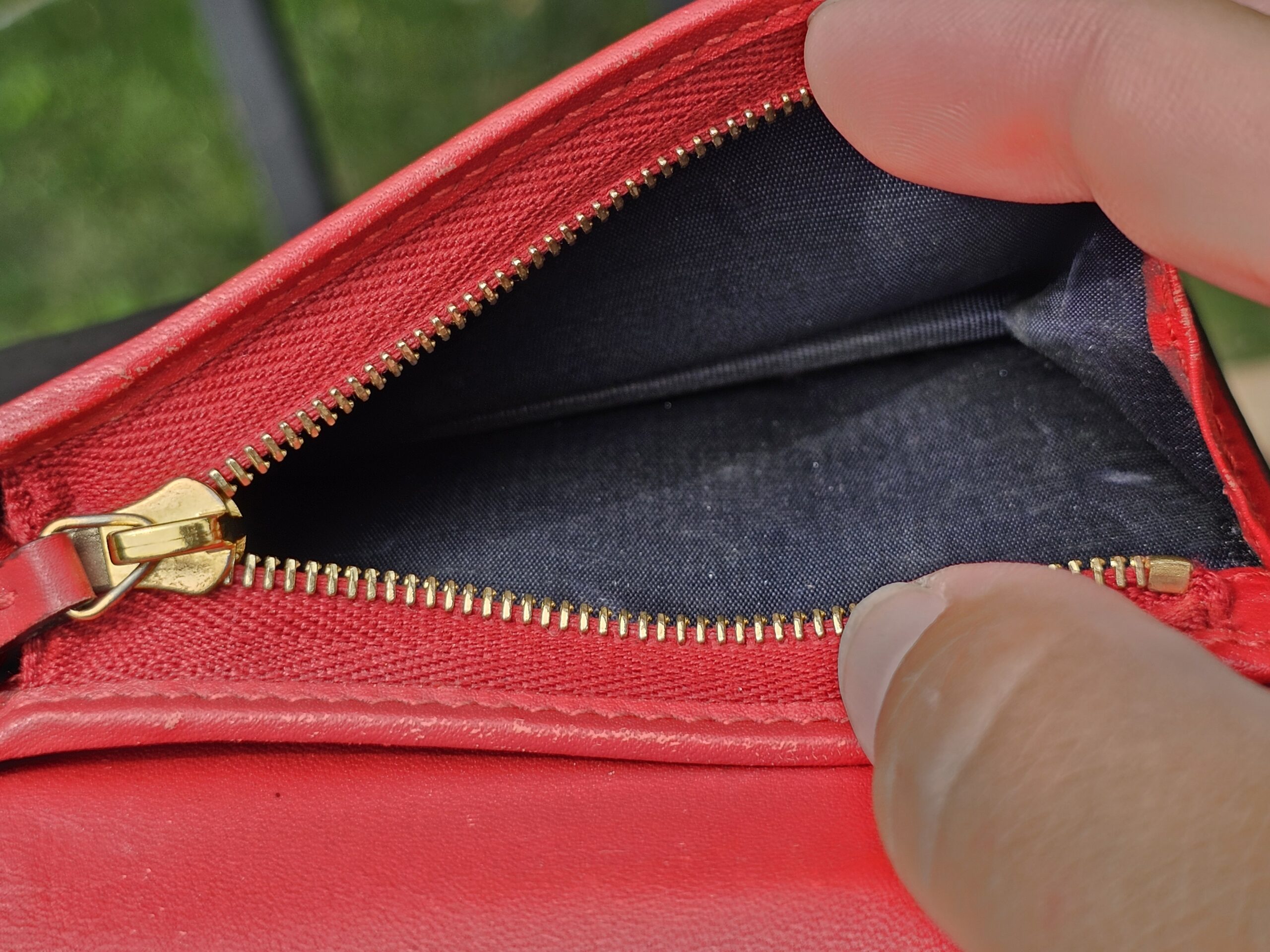Zippered coin compartment inside the Gucci GG Supreme Blooms compact wallet