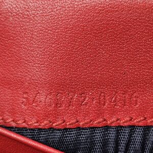 Style code embossed on the red leather inside the Gucci Blooms compact wallet