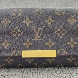 Front of the Louis Vuitton Favorite PM showing the Monogram canvas and gold-tone LV plate