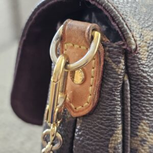 Gold-tone ring and chain hardware on the Louis Vuitton Favorite PM