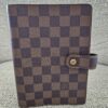 Louis Vuitton Medium Ring Agenda in Damier Ebene canvas with a snap tab closure