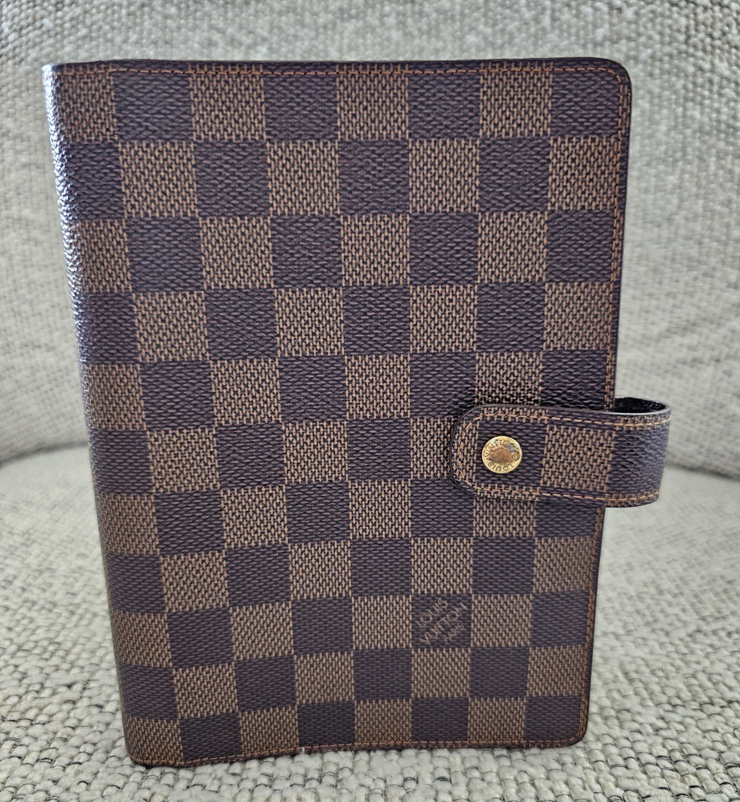 Louis Vuitton Medium Ring Agenda in Damier Ebene canvas with a snap tab closure