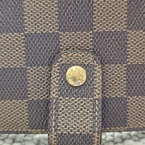 Gold-tone snap tab closure on the Louis Vuitton Damier Ebene Medium Ring Agenda