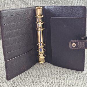 Interior of the Louis Vuitton Medium Ring Agenda with card slots and 6-ring hardware