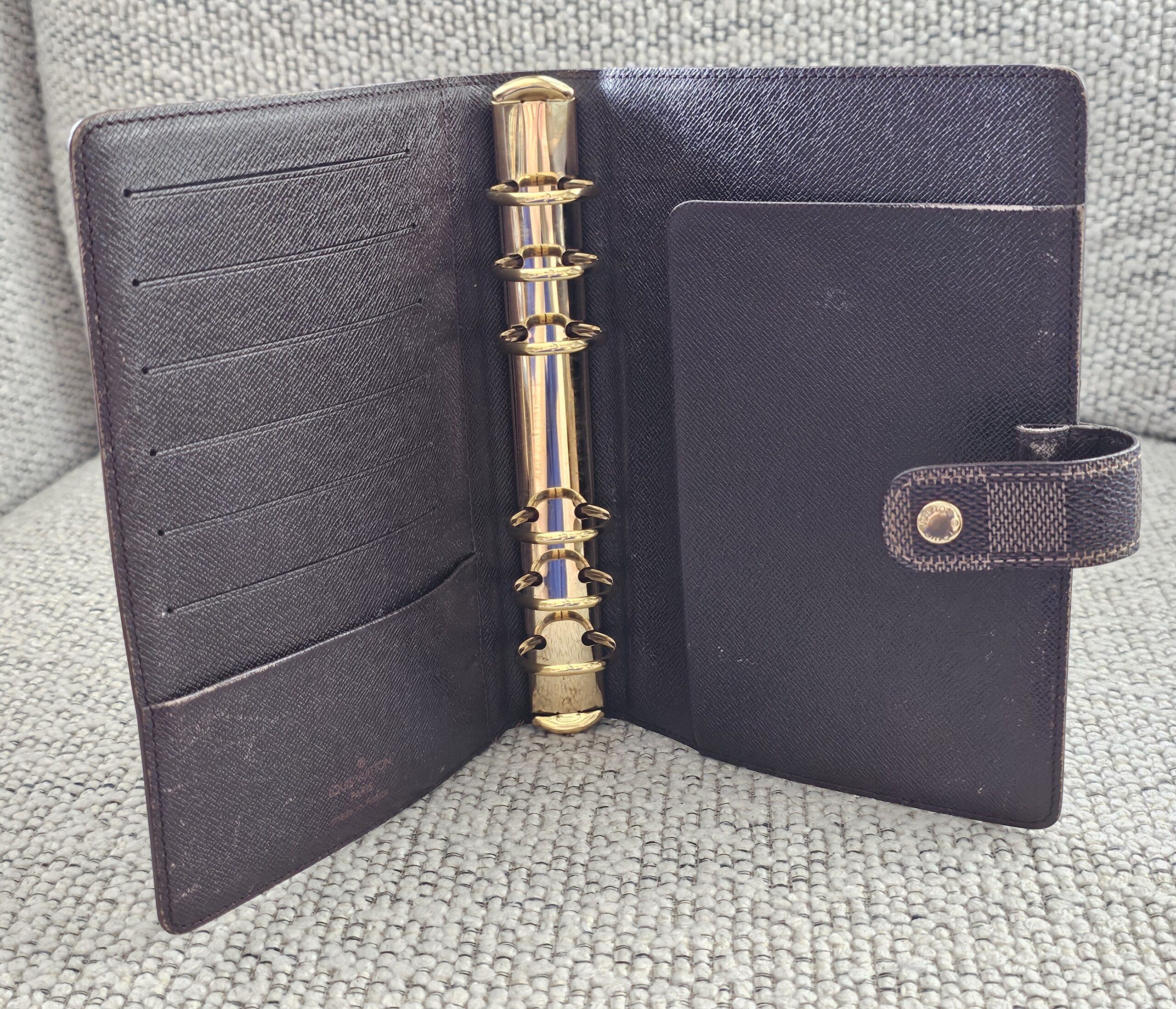 Interior of the Louis Vuitton Medium Ring Agenda with card slots and 6-ring hardware