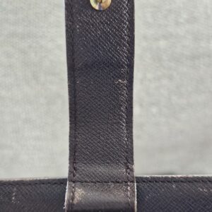 Snap tab area of the Louis Vuitton agenda showing wear from previous use