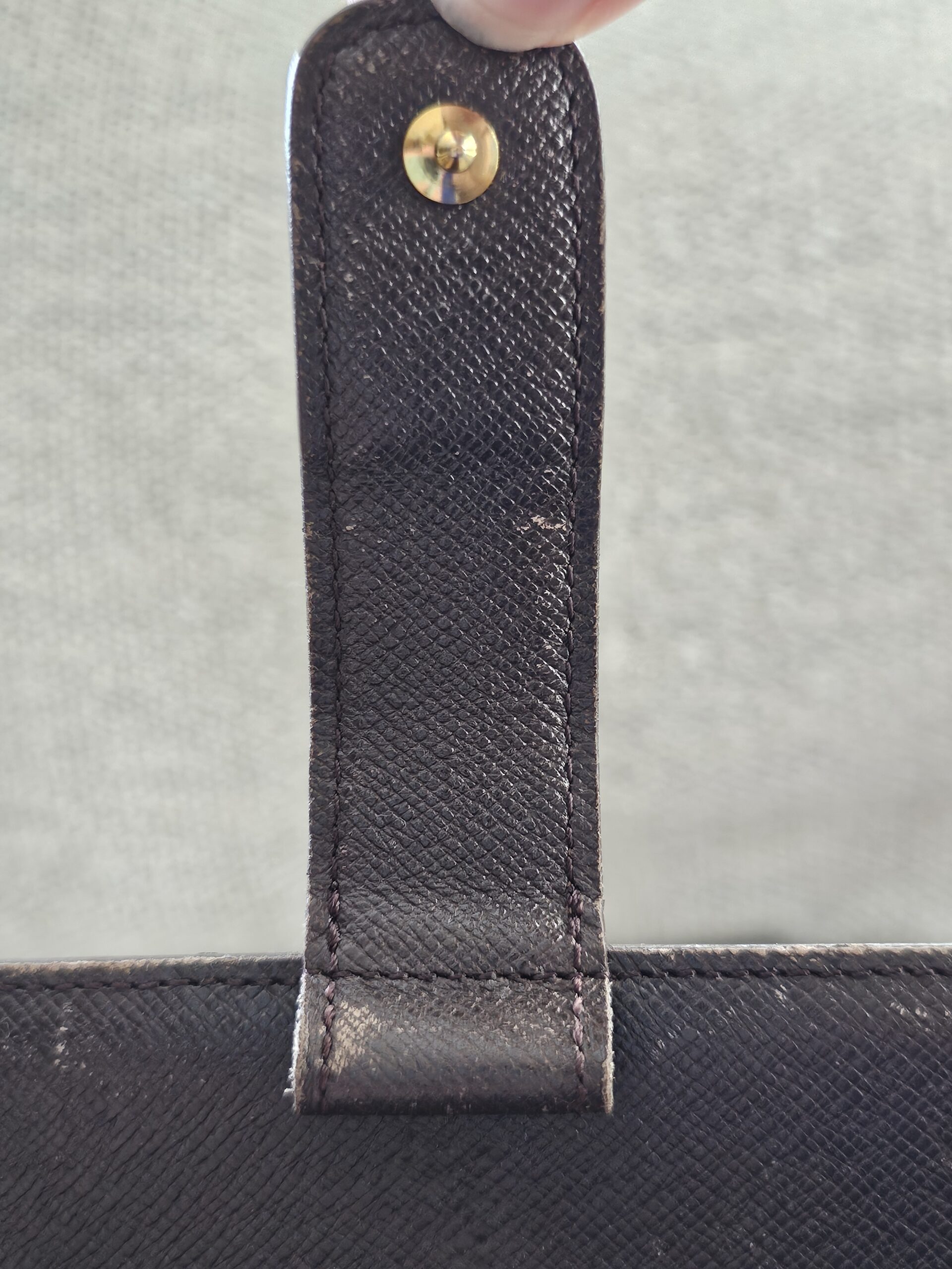 Snap tab area of the Louis Vuitton agenda showing wear from previous use