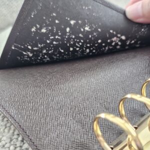 Interior pocket of the Louis Vuitton Medium Ring Agenda showing peeling and deterioration